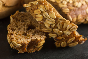 Breaking Bread Homemade bread loaf on rustic dark background