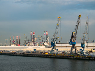 Fototapeta na wymiar Rotterdam, Netherlands - May 08, 2020: evening view on the cargo port buildings infrastructure from the cruise ship
