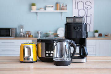 Different household appliances on table in kitchen