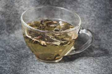 glassy cup with green leaf tea 