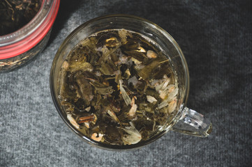 glassy cup with green leaf tea 