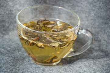 glassy cup with green leaf tea 