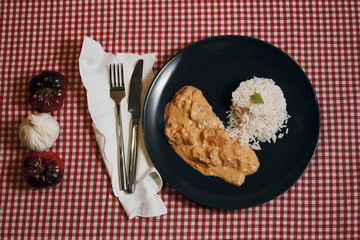 chicken strogonoff plate with knife and fork in restaurant zenith view