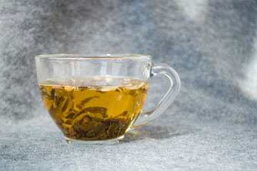glassy cup with green leaf tea 