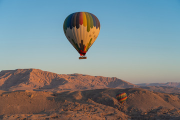 Hot air Balloons over Valley of the King in Luxor city in a morning sunrise, Upper Egypt
