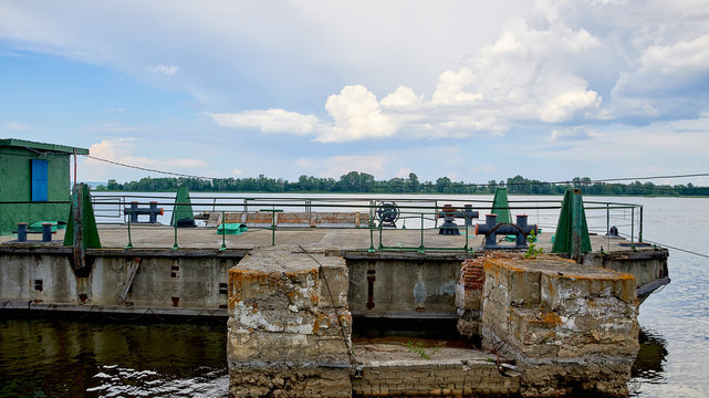 Old pier on the Volga river. An old, dilapidated boat dock.