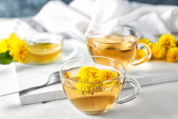 Healthy dandelion tea with honey on table