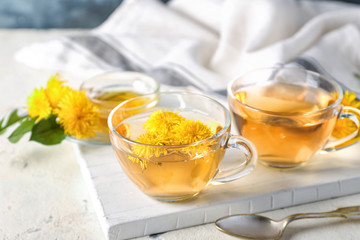 Healthy dandelion tea with honey on table