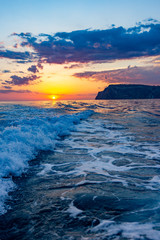 Fototapeta na wymiar Raging sea waves at sunset in the ocean. Storm clouds on the sea.