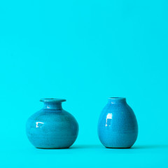 Different vases on color background