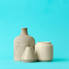 Different vases on color background