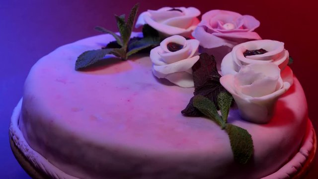 Mastic chocolate cake with pink flowers and mint