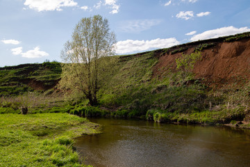 spring landscape, a river near the shore with a large ravine