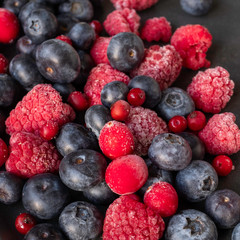 wildberies, raspberries and blackberries on black plate