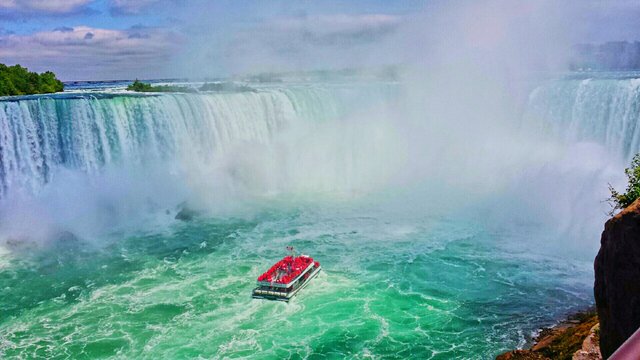 High Angle View Of Red Boat Sailing Against Niagara Falls