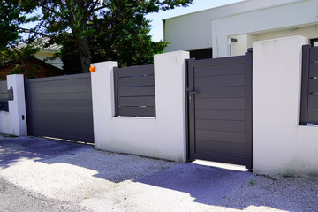 suburb home grey brown dark metal aluminum gate slats portal access house door