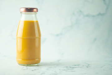 Thai milk tea in retro glass bottle with marble background