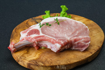 Raw pork bone steak over wooden