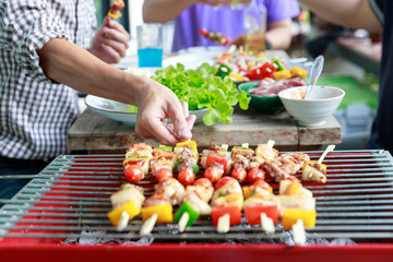 Friends having party and cooking barbecue in gardern.