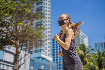 Woman runner wearing medical mask. Running in the city against the backdrop of the city. Coronavirus pandemic Covid-19. Sport, Active life in quarantine surgical sterilizing face mask protection
