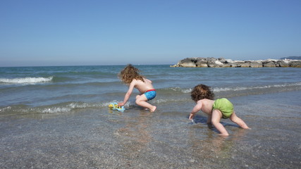 Kids playing on the beach with water