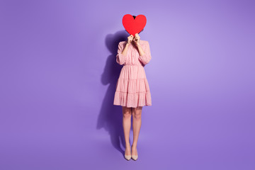 Full length photo of cute sweet lovely girl feel shy valentine day date close cover face red big paper card heart wear good look pastel clothes isolated violet color background