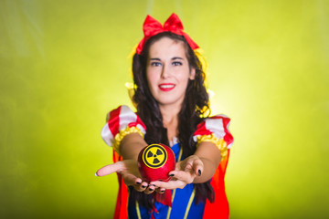 Woman wearing a fairy tale dress holding an apple with radiation symbol. Environmental problems concept, radioactive disaster as danger on nature.