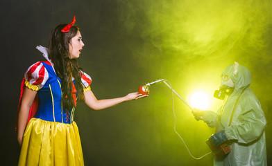 Woman holding hazardous radioactive apple. Nuclear and radiation measurement concept.