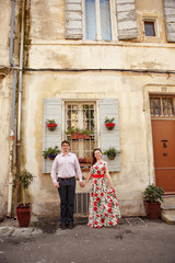Fototapeta na wymiar Couple stand in background of window in Provence