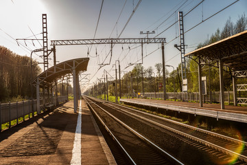 Fototapeta na wymiar Empty railway station with sun exposure. Travel and tourism.