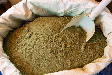 Bag filled with henna powder at Kemeralti Market in the city center of Izmir in Turkey. Natural dye for skin or hair. Focus on center.