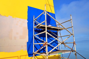 Repainting the ship’s funnel and drawing the logo of the shipowner with members of the ship’s...