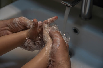 washing hands with soap.  Washing a child’s hands with soap and water to prevent coronavirus and hygiene to stop the spread of coronavirus. wash your hands with soap and hot water