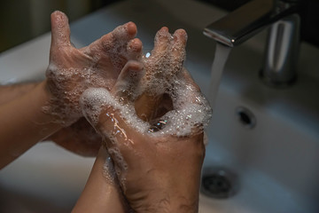 washing hands with soap.  Washing a child’s hands with soap and water to prevent coronavirus and hygiene to stop the spread of coronavirus. wash your hands with soap and hot water