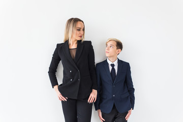 Teenager and single parent - Young mother and son standing together on white background.
