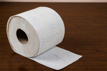 White toilet paper on a wooden table