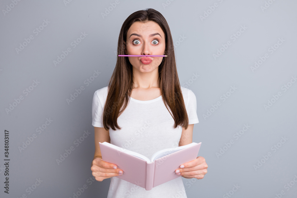 Poster Portrait of funny playful childish girl put nose pencil have distance learning break want joke hold copybook wear stylish clothes isolated over gray color background