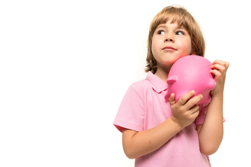 Fototapeta na wymiar charming cute child holding a piggy bank on a white background with copy space close-up