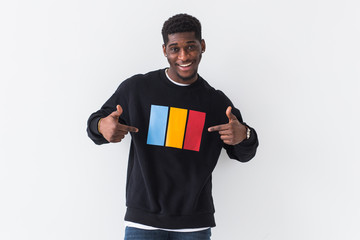 Handsome African American man posing in black sweatshirt on a white background. Youth street fashion photo with afro hairstyle.
