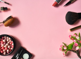 Obraz na płótnie Canvas A set of decorative cosmetics on a pink background. Top viev. Flat lay.