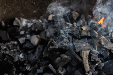 the coals texture smoldering and burning in the brazier with smok