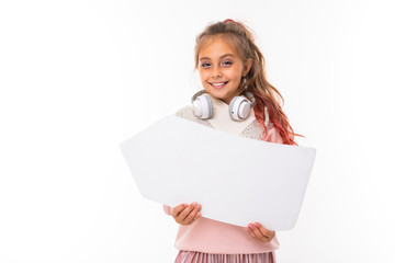 portrait of a beautiful charming young cute girl in a casual winter look with white headphones and on a white background