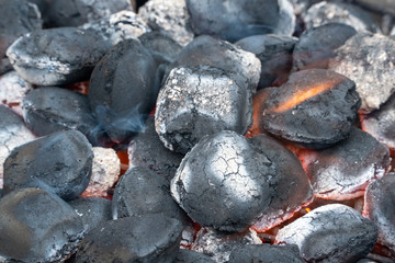 BBQ Grill Pit With Glowing And Flaming Hot Charcoal Briquettes, Food Background Or Texture, Close-Up.