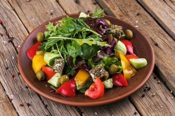 salad with vegetables and greens on wooden table