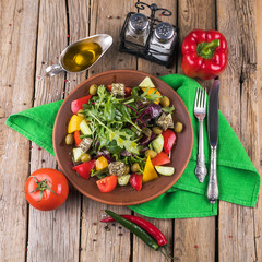 salad with vegetables and greens on wooden table