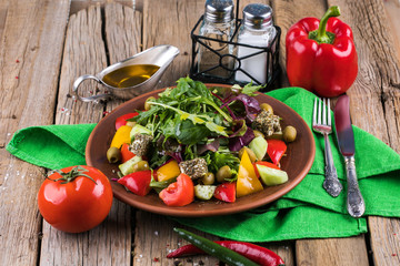 salad with vegetables and greens on wooden table