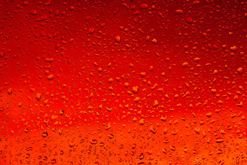 Drops of water on a glass of dark beer or red wine. Background, Texture.
