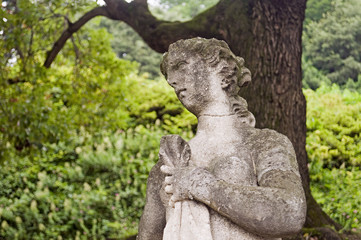 Fototapeta na wymiar old stone statue in a garden