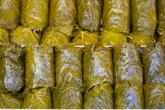 Pickled grape leaves close-up. Grape leaves for preparation of traditional oriental dishes and snacks on counter of oriental bazaar
