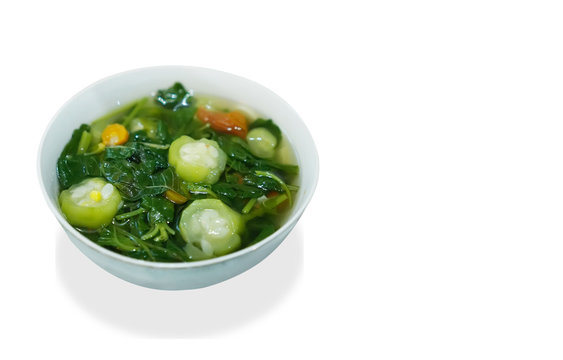 Sayur Bening Bayam or Spinach Clear Soup on white background. Boiled spinach with corn.